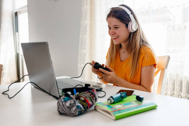 college girl takes a break college girl takes a break gaming laptop stock pictures, royalty-free photos & images